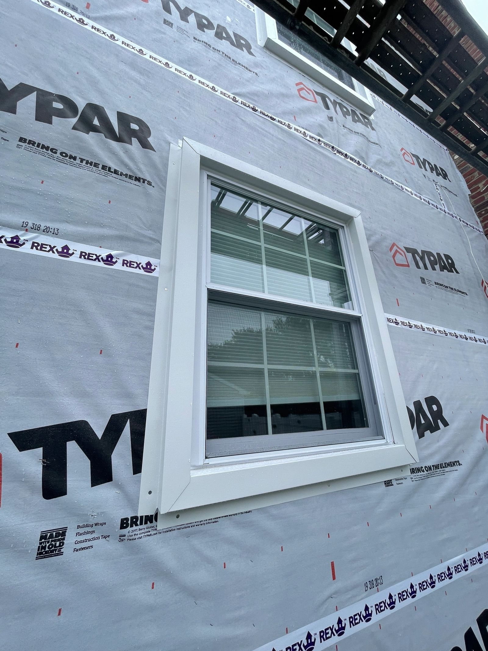 New energy-efficient window installed on exterior with TYPAR house wrap