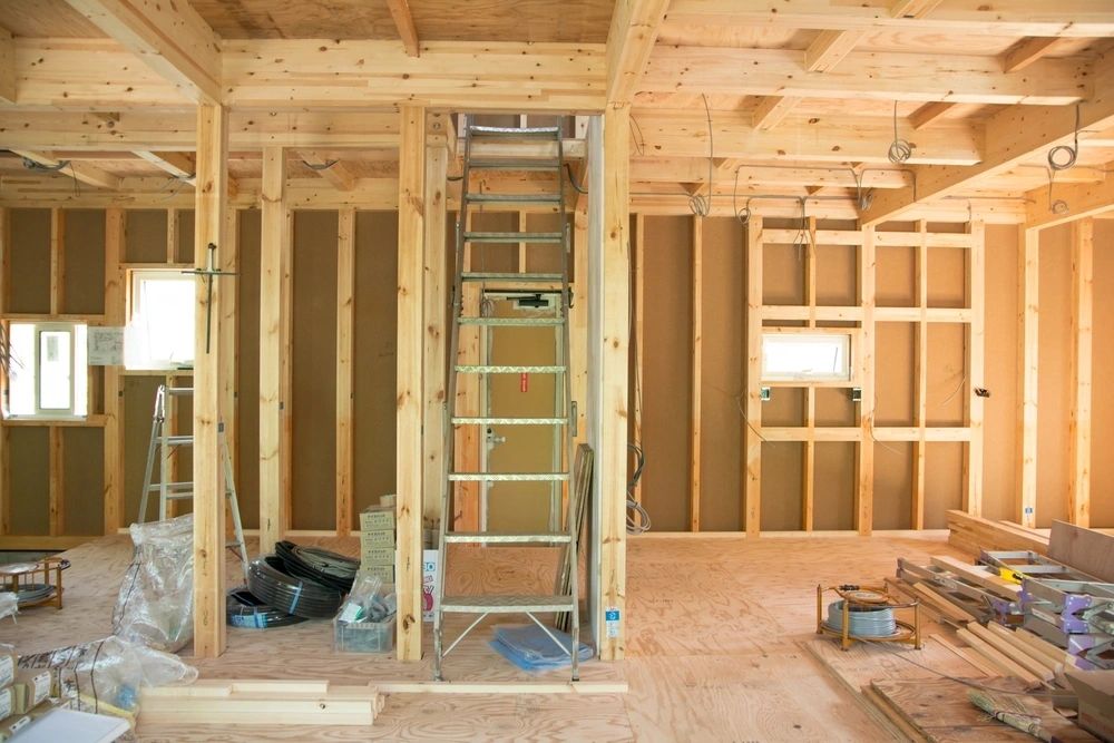Interior framing with exposed studs and ladder during home remodel