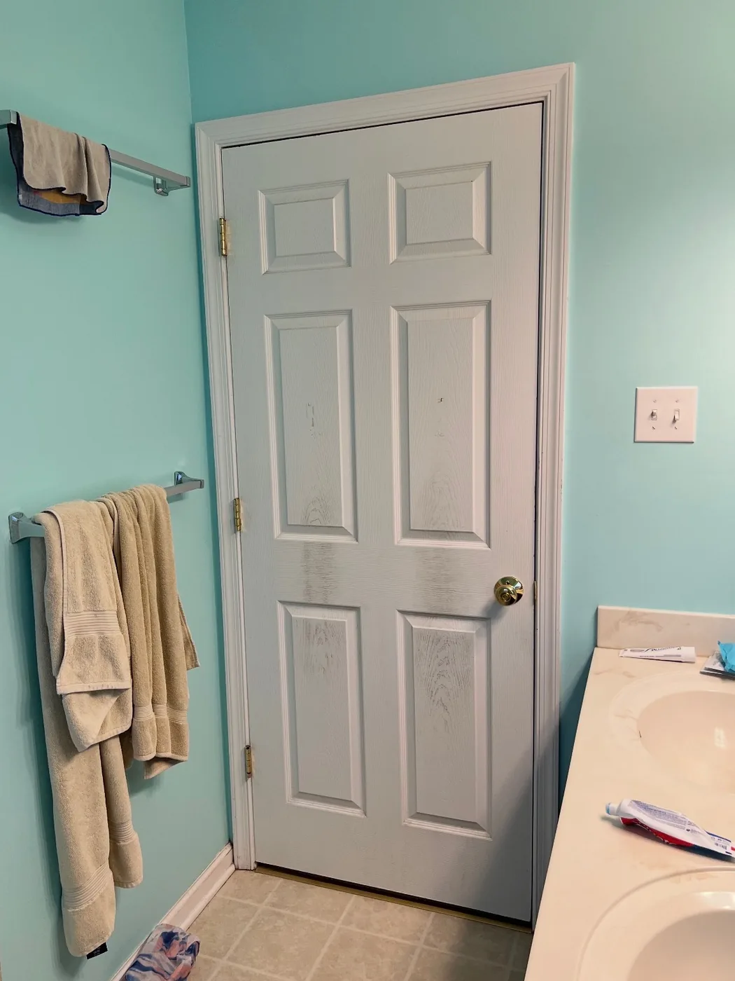 Dated bathroom before remodel with teal walls, vinyl tile floor and cultured marble vanity in Bucks County PA
