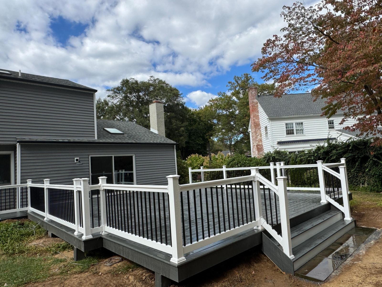 Custom composite deck with white railings built by Altieri and Sons