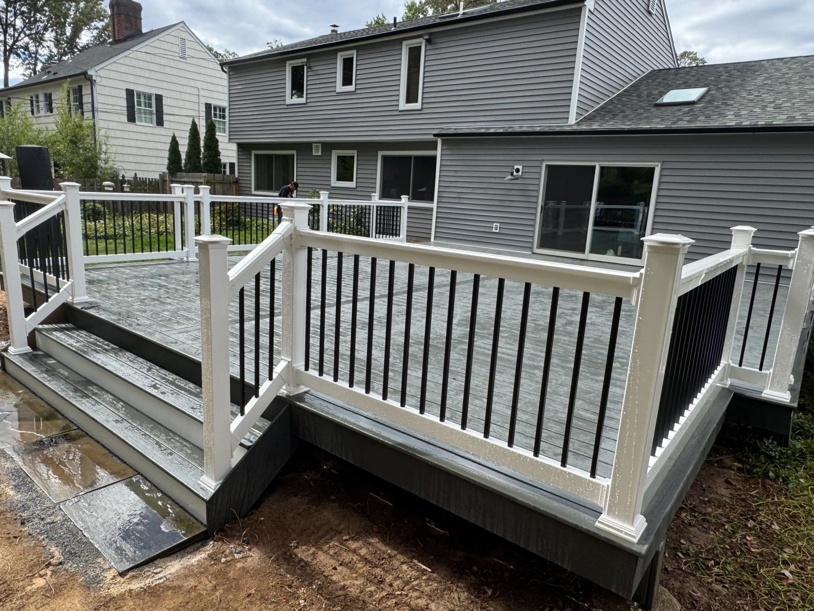 Front view of newly built composite deck with stairs and white railing