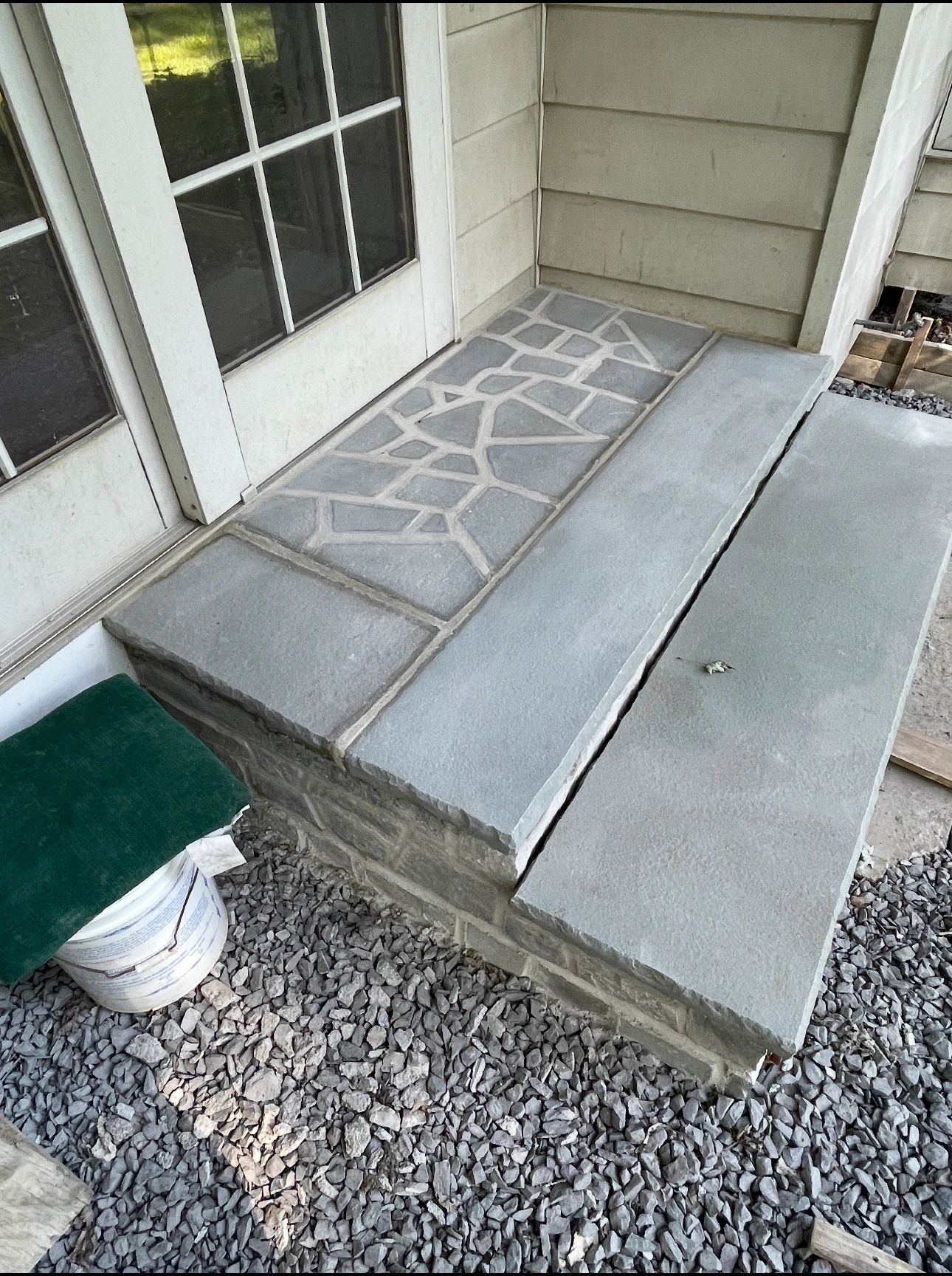Custom flagstone and concrete entry steps with decorative inlay pattern