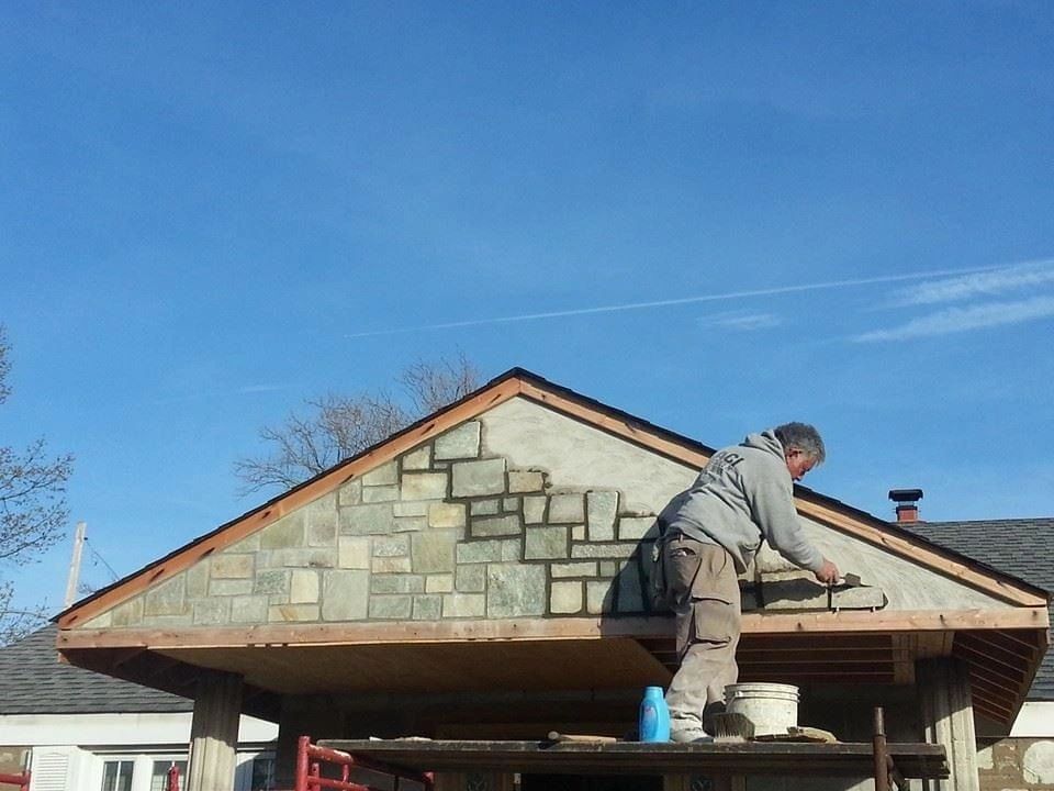 Natural stone veneer installation on home exterior by Altieri and Sons