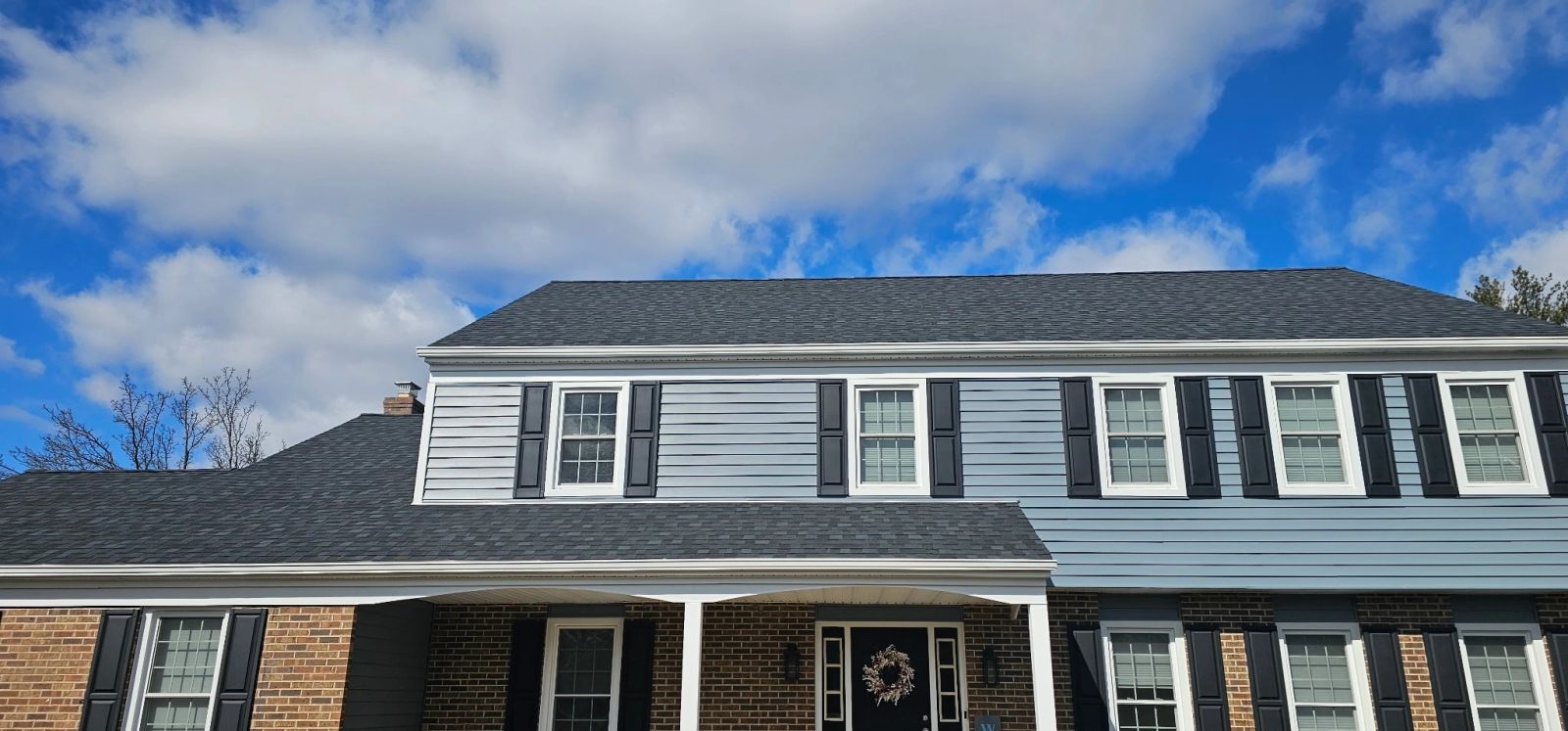Colonial home with new siding and shutters by Altieri and Sons