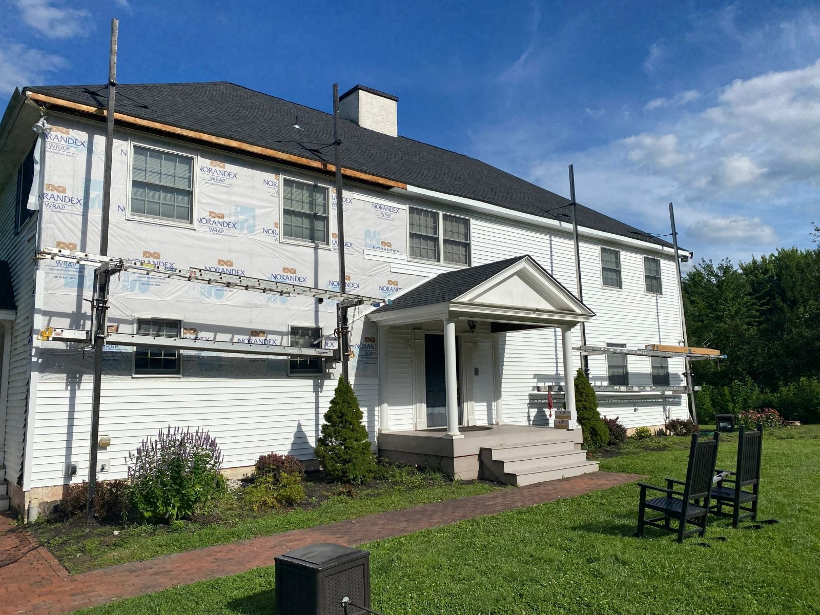 Colonial home with Norandex house wrap during siding replacement