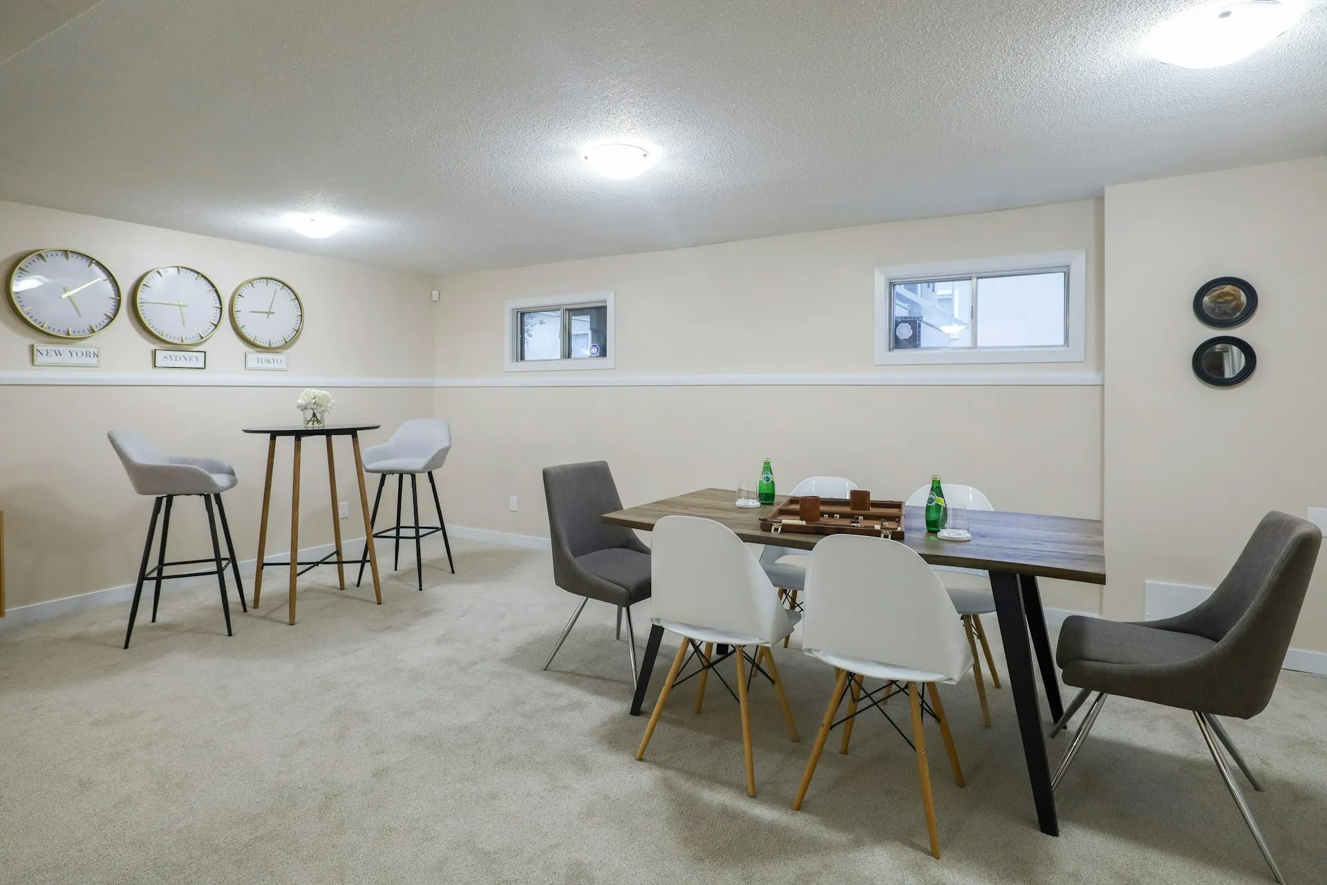 Finished basement dining area with bar stools and table