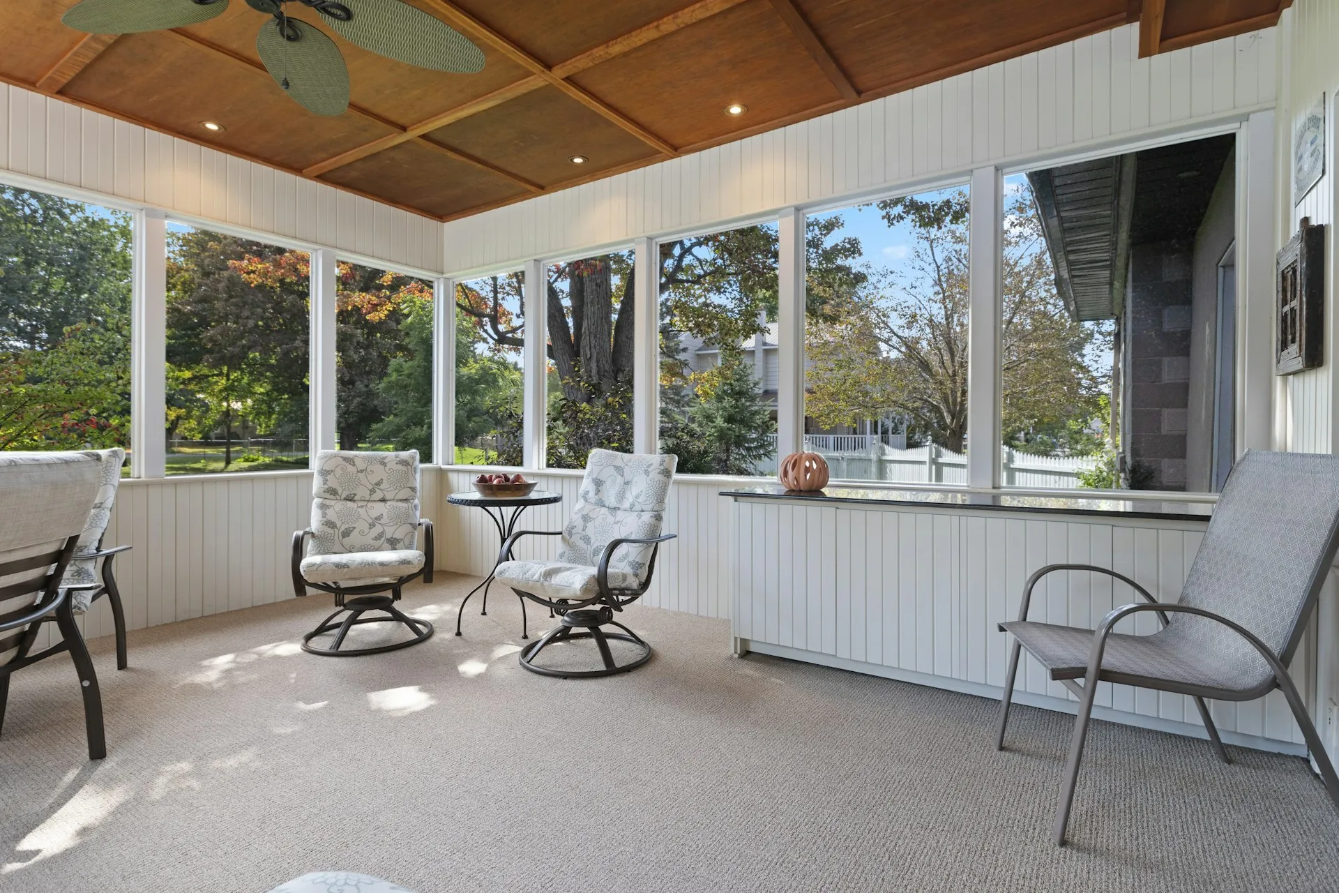 Enclosed porch with seating and table