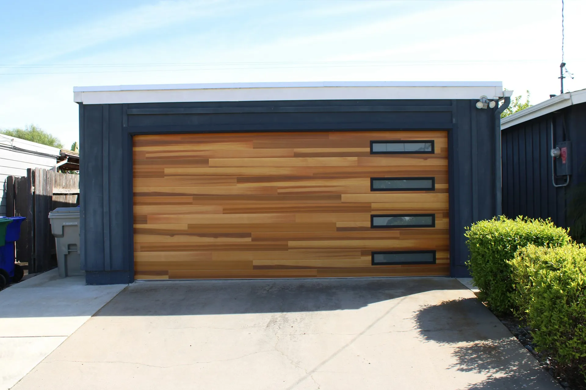 Modern garage door with wood panels and windows