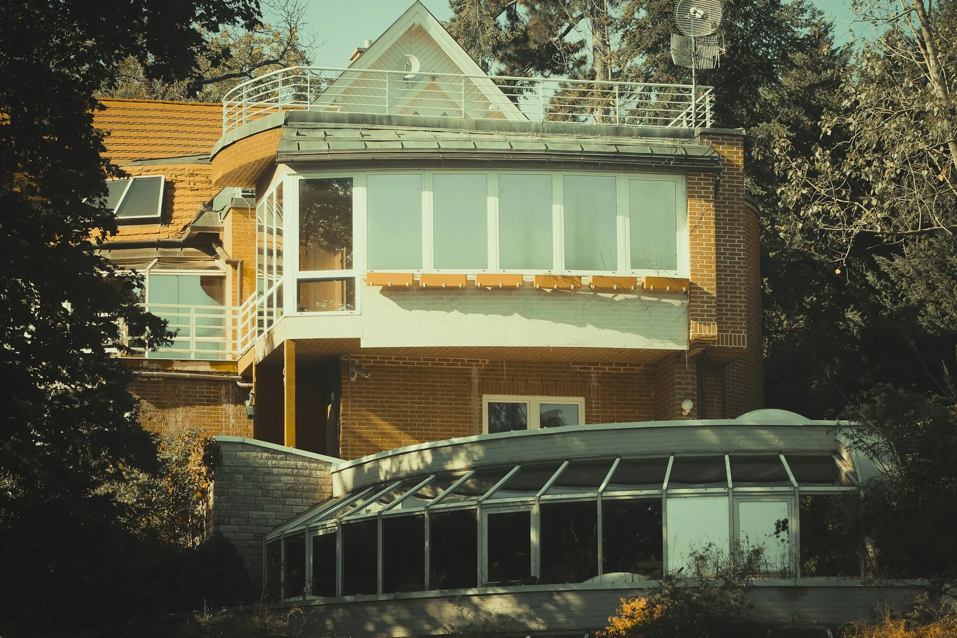 Modern house with sunroom extension and large windows