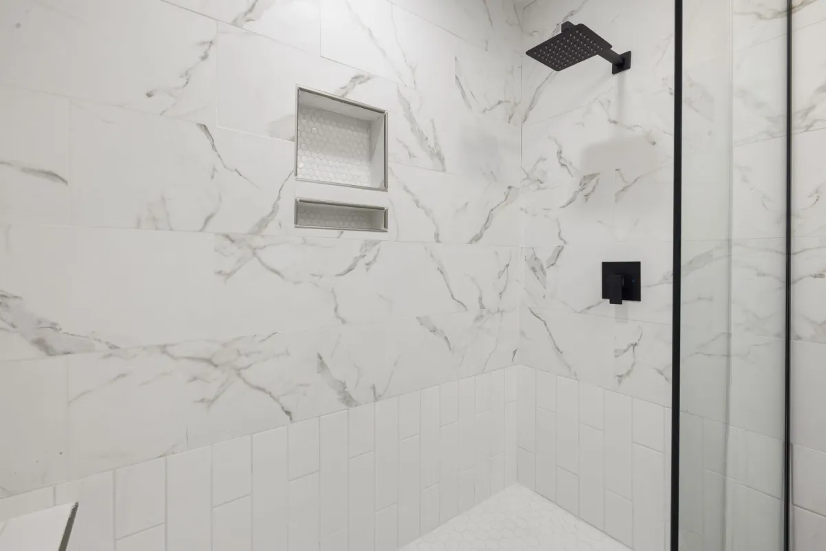 Modern bathroom with tiled walk-in shower and vanity