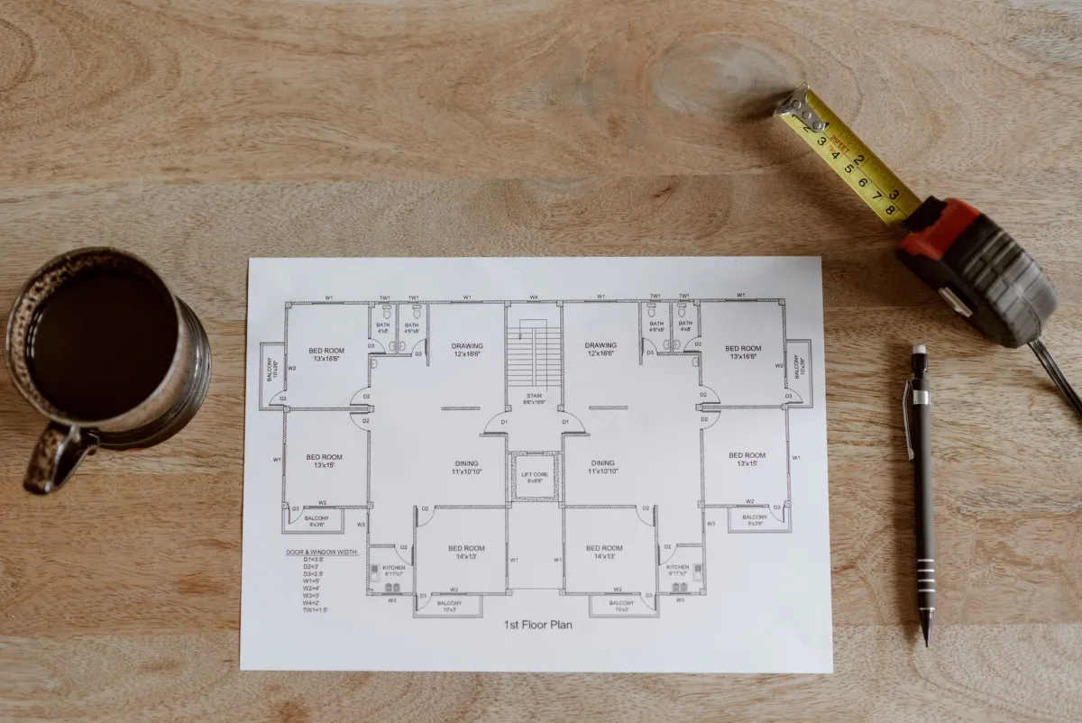 Construction blueprints and tools laid out for a renovation project
